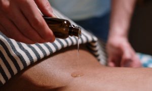 Massage oil applied to persons back